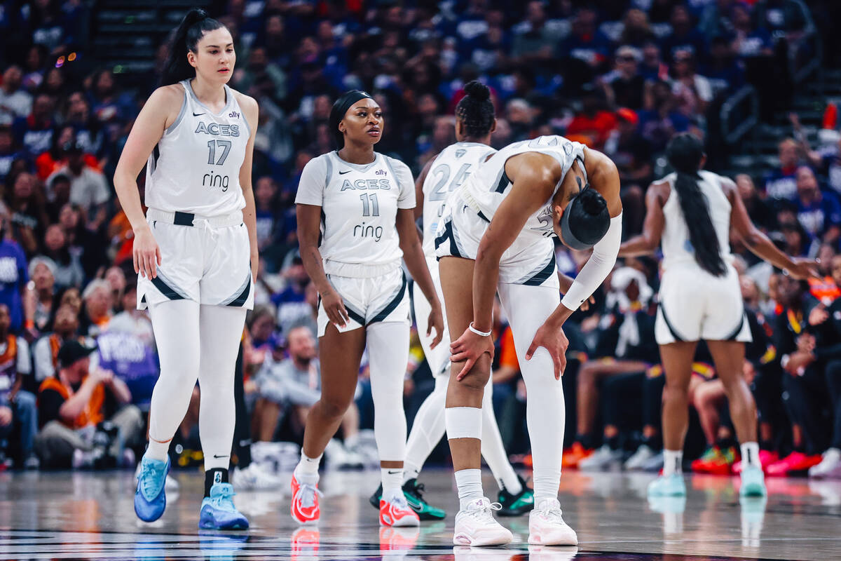 Aces center A'ja Wilson (22) takes a moment after a brief injury to her leg during game fo ...