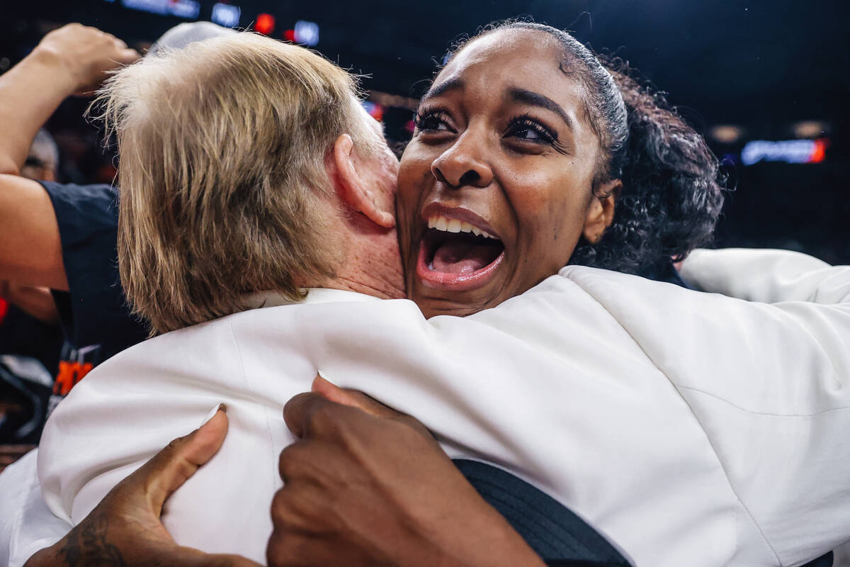 Aces forward Cheyenne Parker-Tyus hugs Aces owner mark Davis after winning the wnba championshi ...