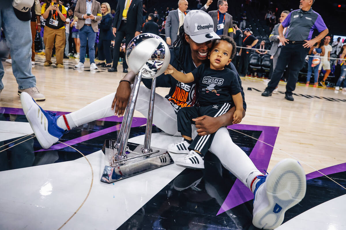 Aces guard Chelsea Gray celebrates winning the WNBA championship with her son, Lennox, followin ...