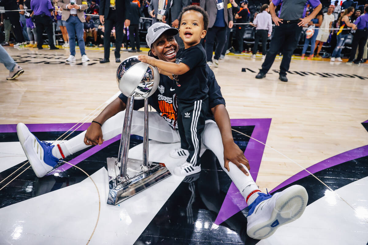 Aces guard Chelsea Gray celebrates winning the WNBA championship with her son, Lennox, followin ...
