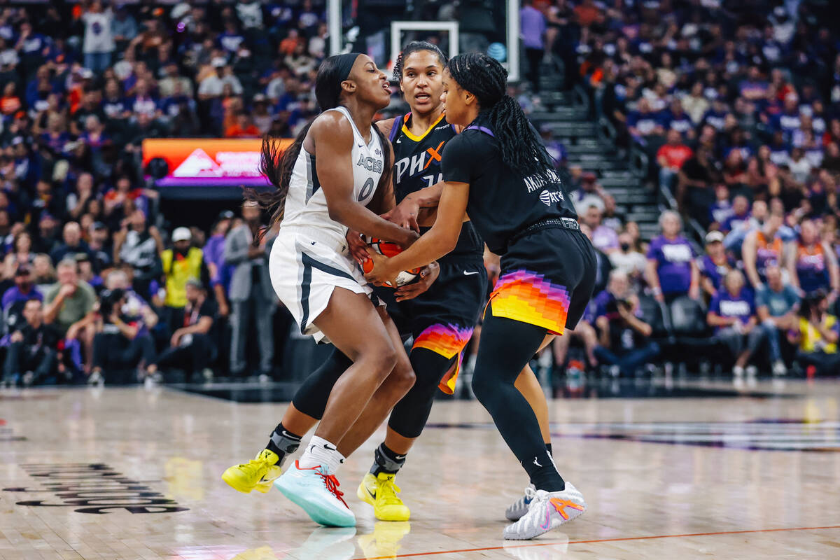 Aces guard Jackie Young (0) fights Phoenix Mercury forward Alyssa Thomas (25) and Phoenix Mercu ...