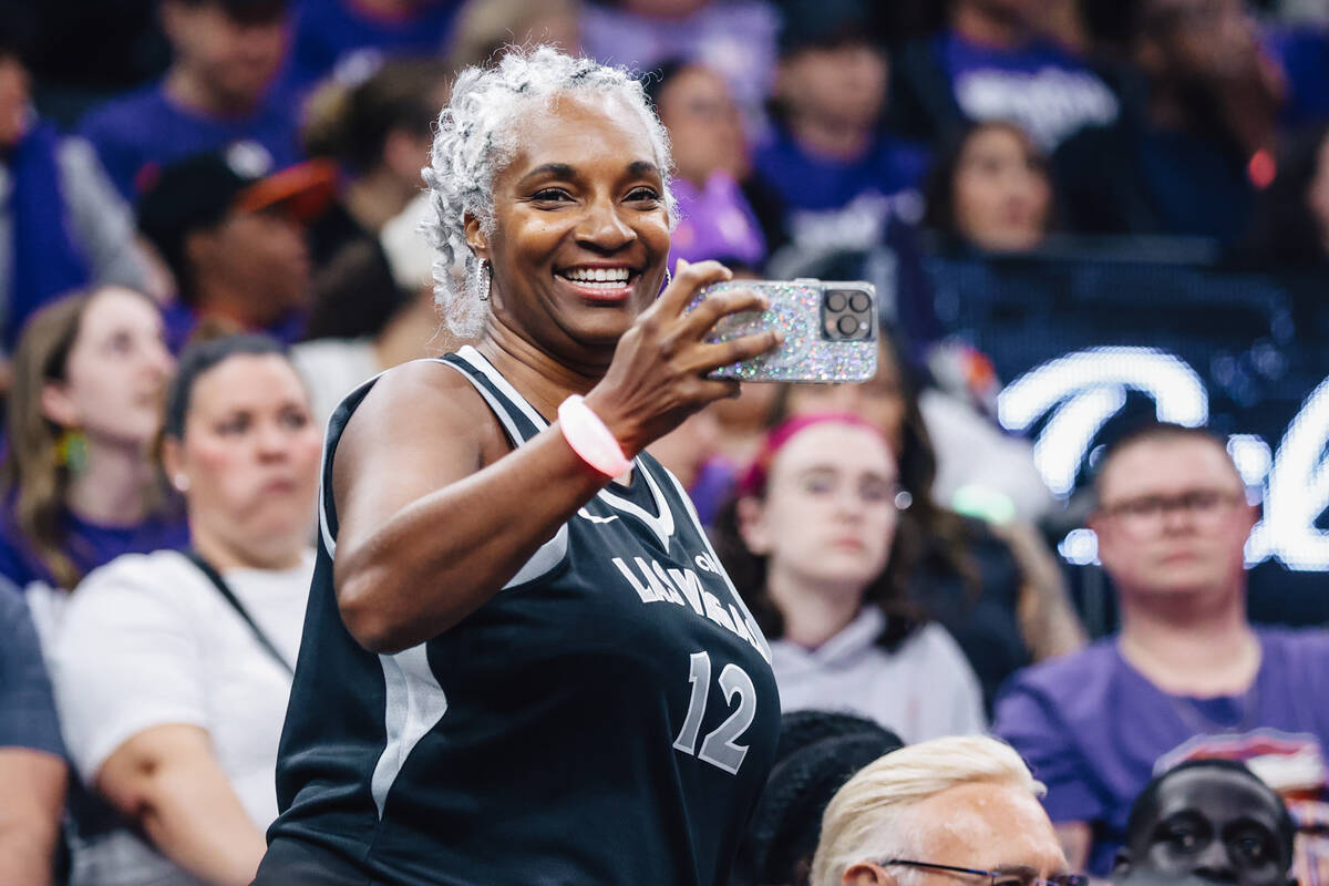 An Aces fan records game action during game four of a WNBA finals match up between the Aces and ...