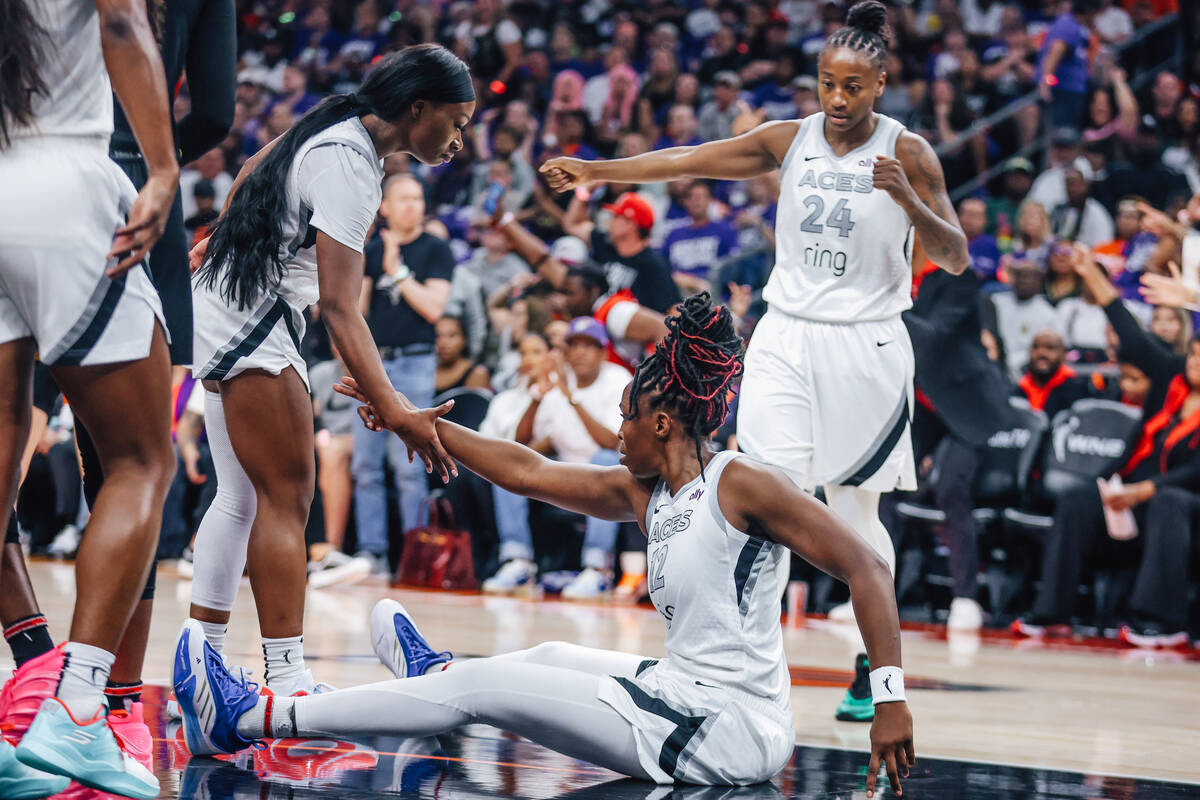 Aces guard Chelsea Gray (12) points to the other side of the court after drawing an offensive f ...