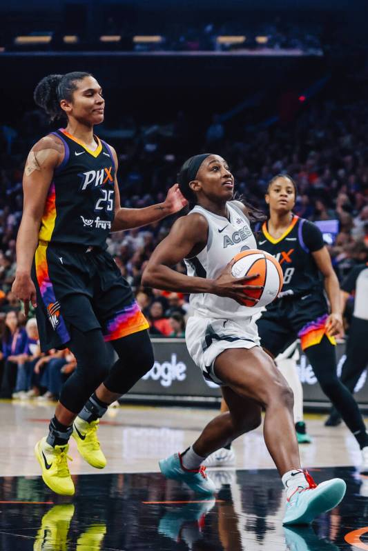 Aces guard Jackie Young (0) drives to the basket during game four of a WNBA finals match up bet ...