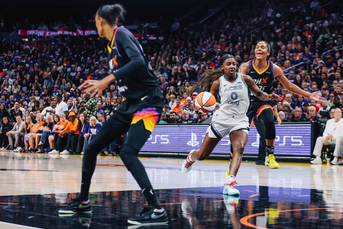 Aces guard Jackie Young (0) rushes to the basket as Phoenix Mercury forward Alyssa Thomas (25) ...