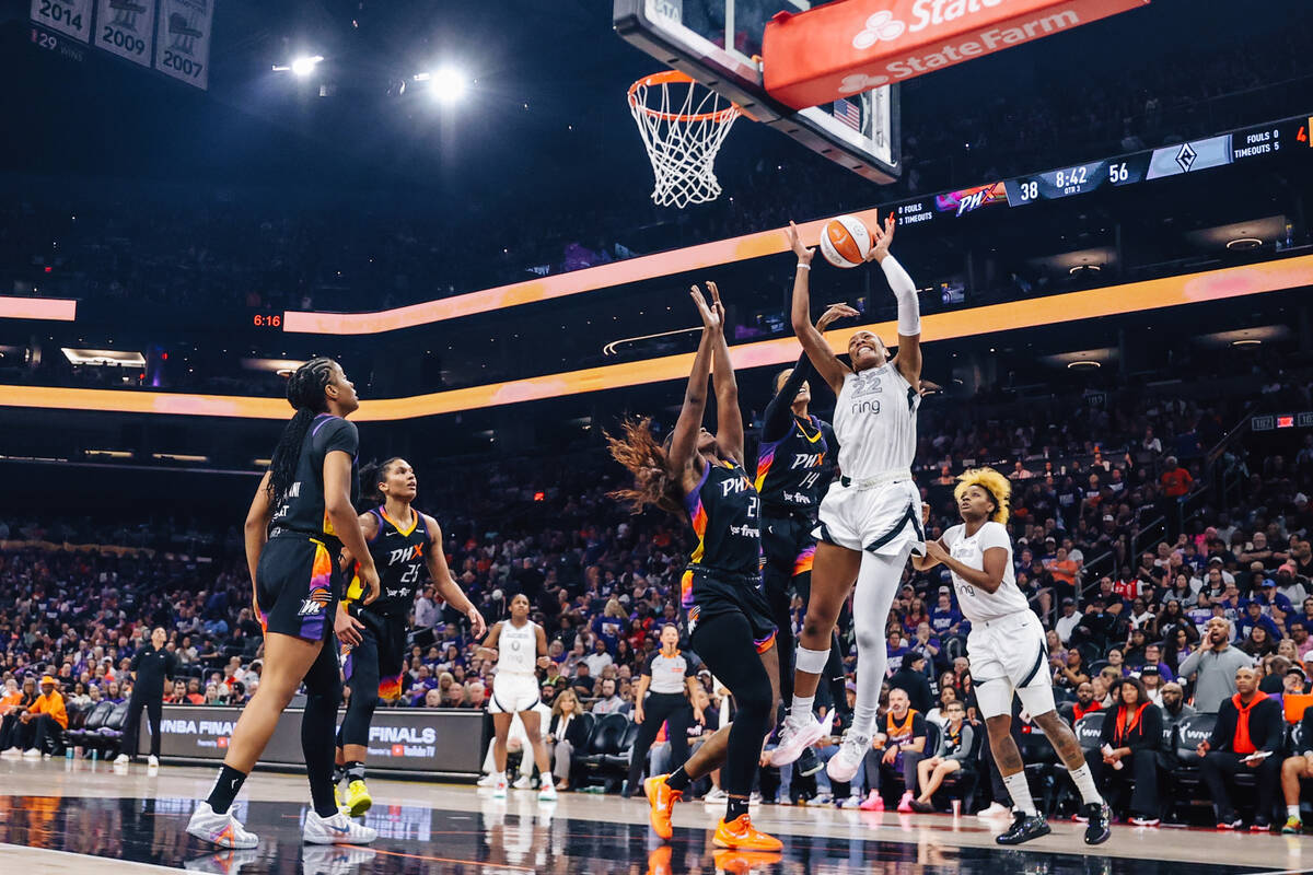 Aces center A'ja Wilson (22) leaps up for the ball during game four of a WNBA finals match ...