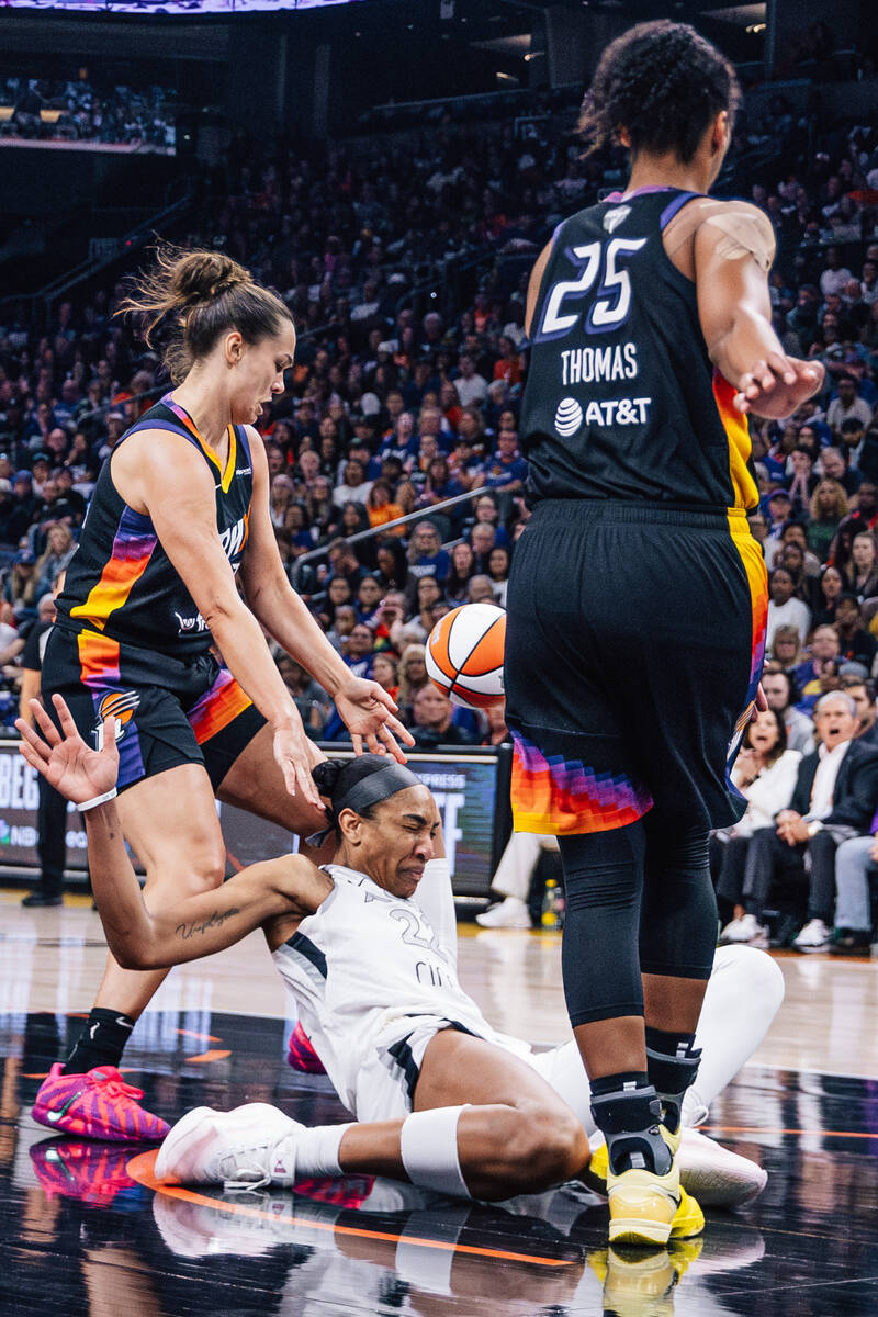 Aces center A'ja Wilson (22) falls during game four of a WNBA finals match up between the ...