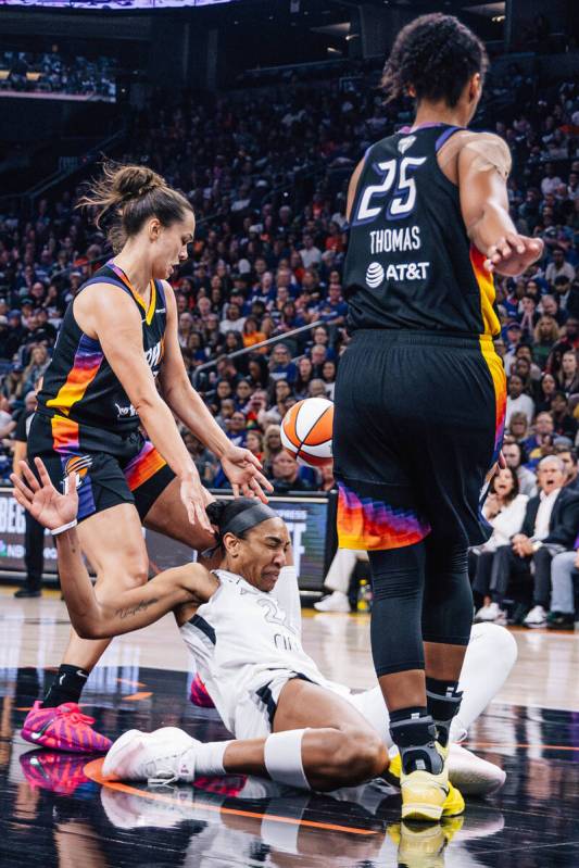 Aces center A'ja Wilson (22) falls during game four of a WNBA finals match up between the ...