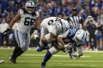 Raiders offensive tackle Stone Forsythe (70) tackles Indianapolis Colts defensive end Laiatu La ...