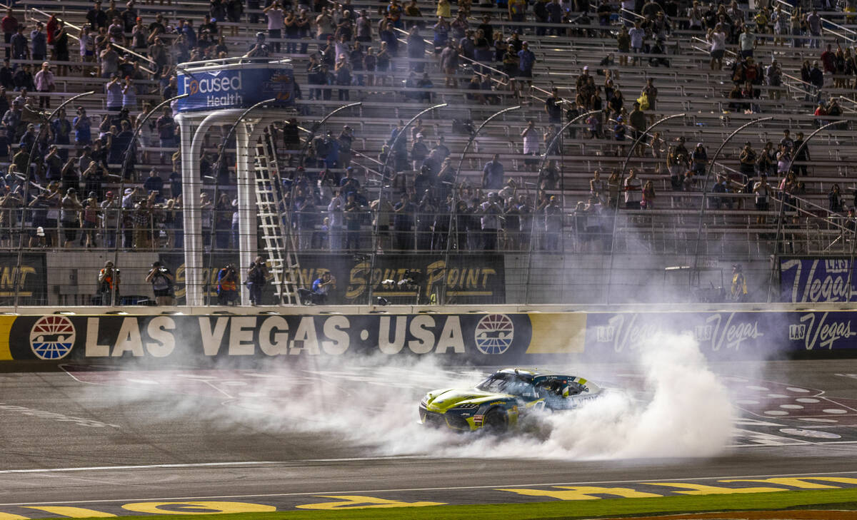 Driver Aric Almirola (19) does a burn out at the start/finish line after winning the Focused He ...
