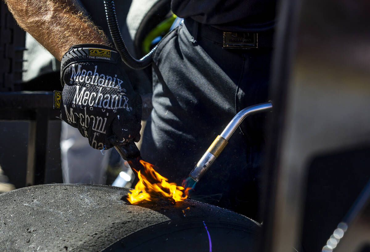 A crew member scapes tires in the pits during the Focused Health 302 NXS Playoff Race day at th ...