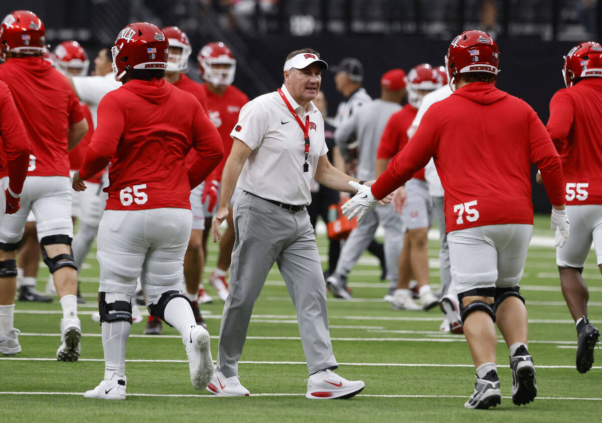 UNLV head coach Daniel Mullen greets his players as they prepare to warm up to face Air Force F ...