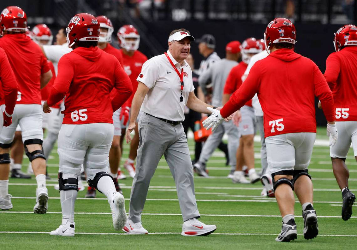 UNLV head coach Daniel Mullen greets his players as they prepare to warm up to face Air Force F ...