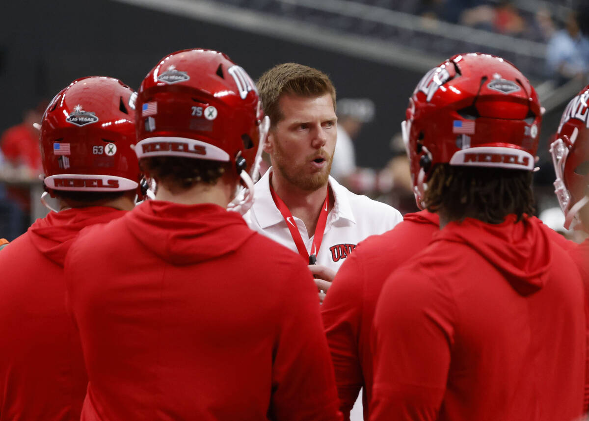 UNLV offensive line coach Mike Sollenne talks to players as they prepare to face Air Force Falc ...