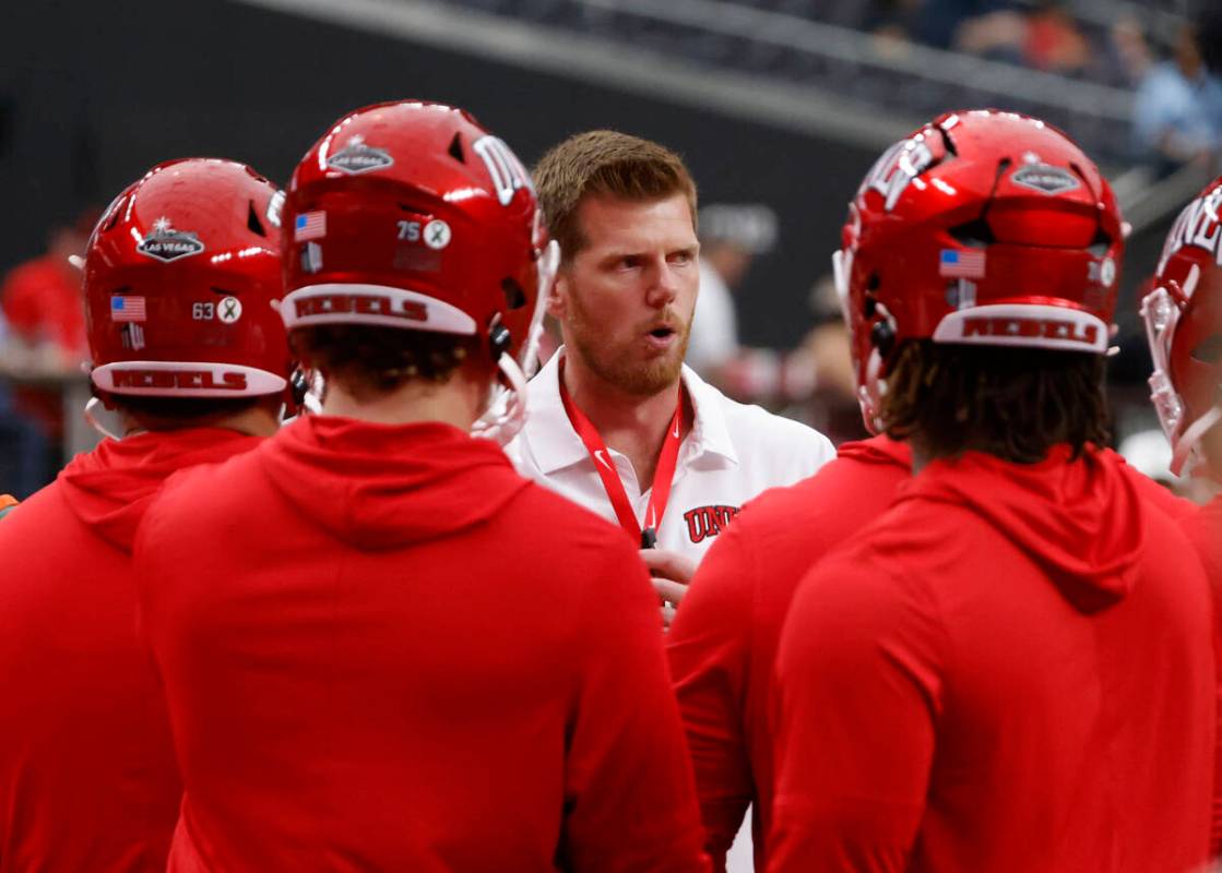 UNLV offensive line coach Mike Sollenne talks to players as they prepare to face Air Force Falc ...