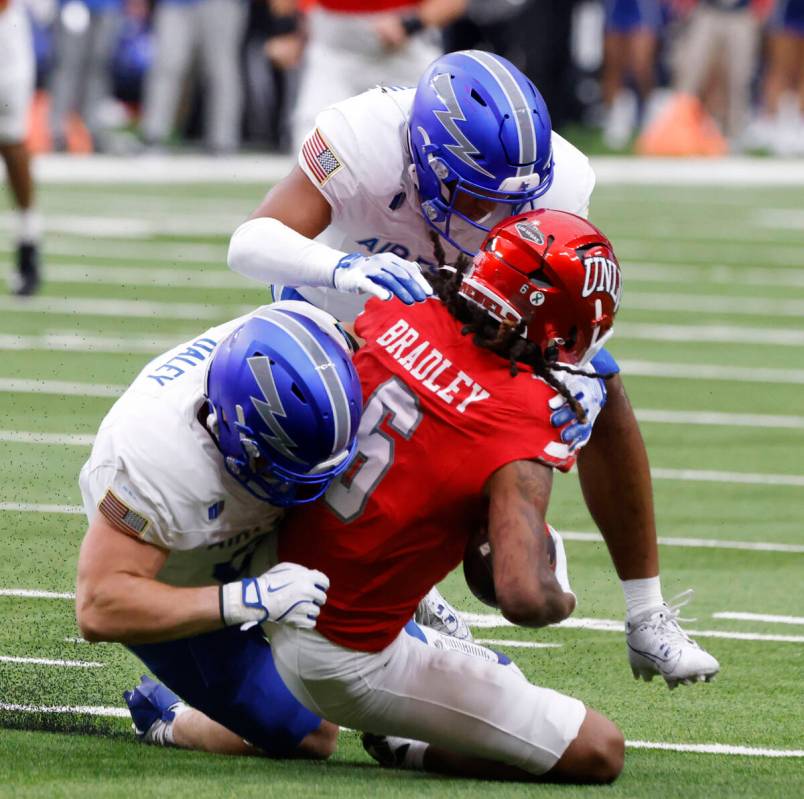 UNLV wide receiver Jaden Bradley (6) is taken down by Air Force Falcons defensive back Nick Bec ...