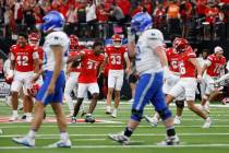 UNLV players celebrate their 51-48 win as Air Force Falcons players walk off the field during t ...