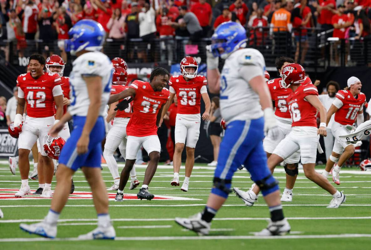 UNLV players celebrate their 51-48 win as Air Force Falcons players walk off the field during t ...