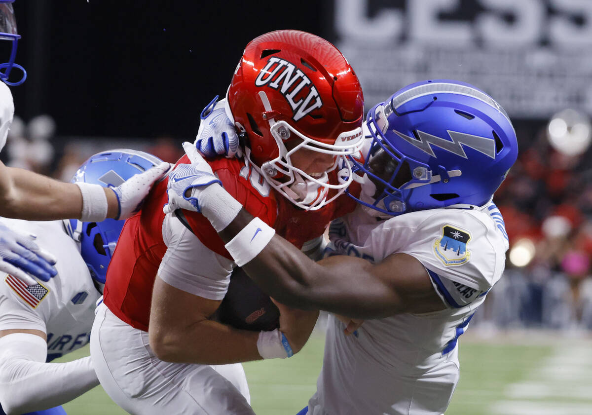 UNLV quarterback Anthony Colandrea (10) scores a touchdown as Air Force Falcons defensive back ...