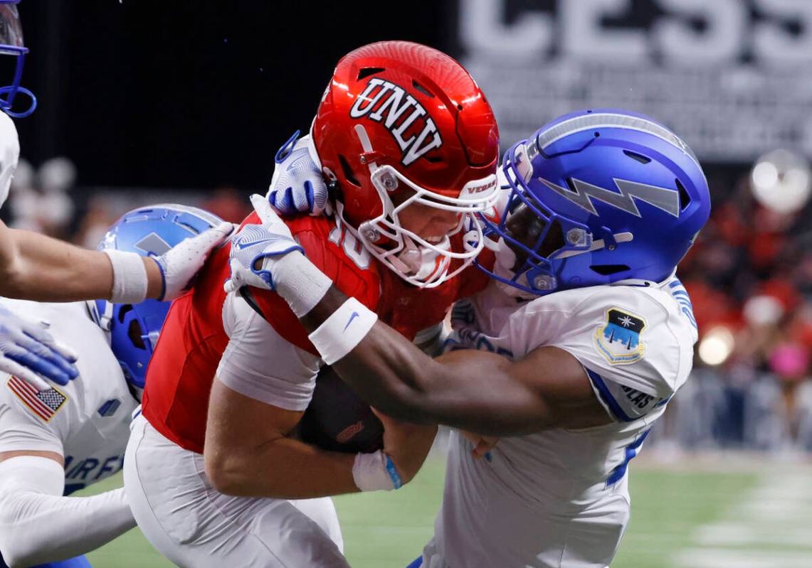 UNLV quarterback Anthony Colandrea (10) scores a touchdown as Air Force Falcons defensive back ...