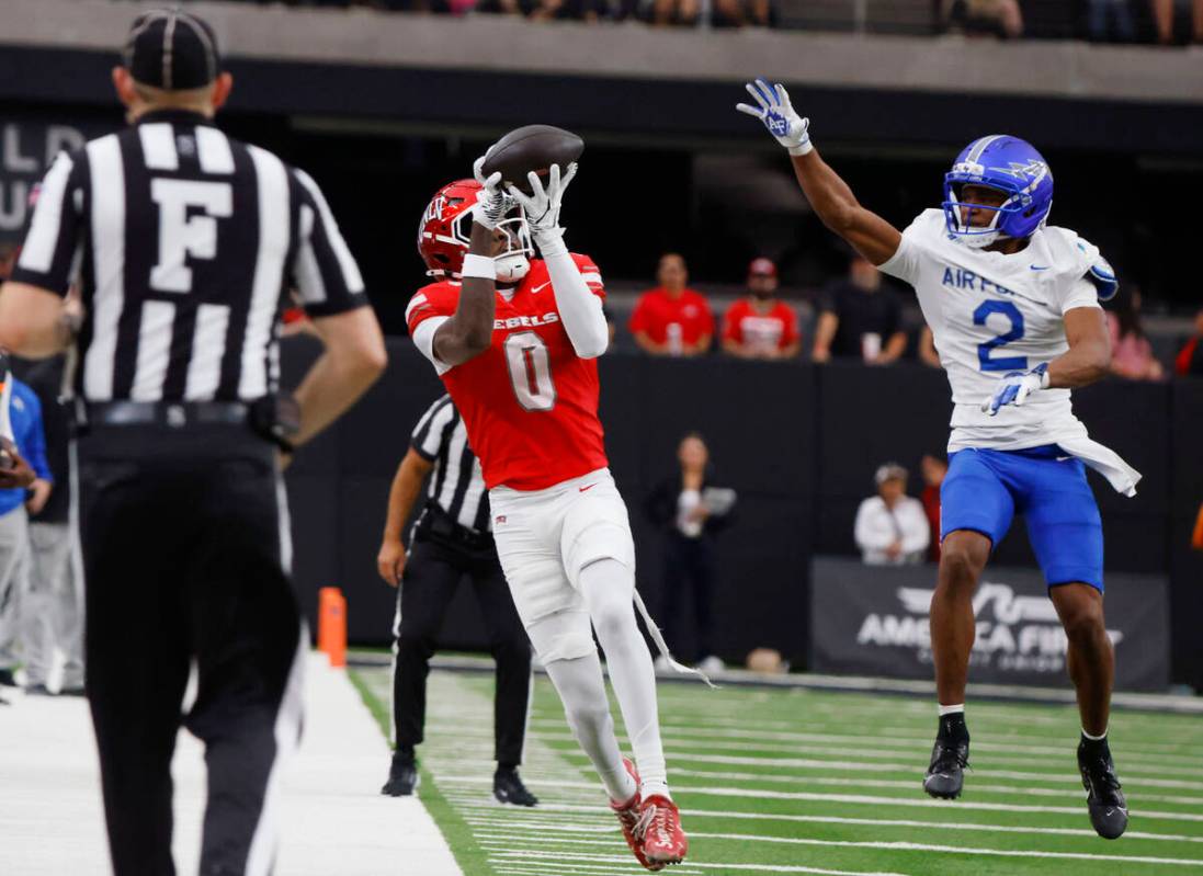 UNLV wide receiver Troy Omeire (0) catches a pass as Air Force Falcons defensive back Korey Joh ...
