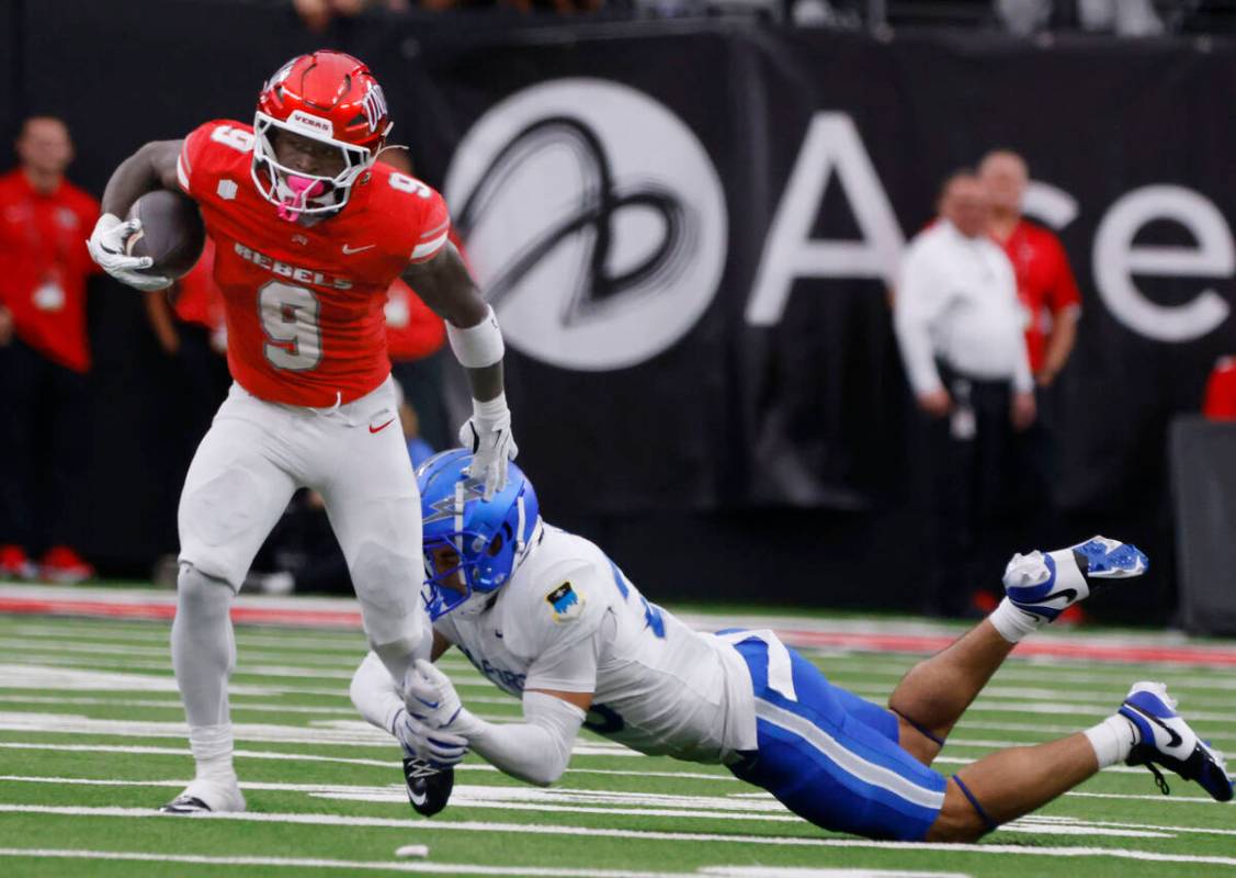 Air Force Falcons defensive back Korey Johnson (2) attempts to trip UNLV running back Jai' ...