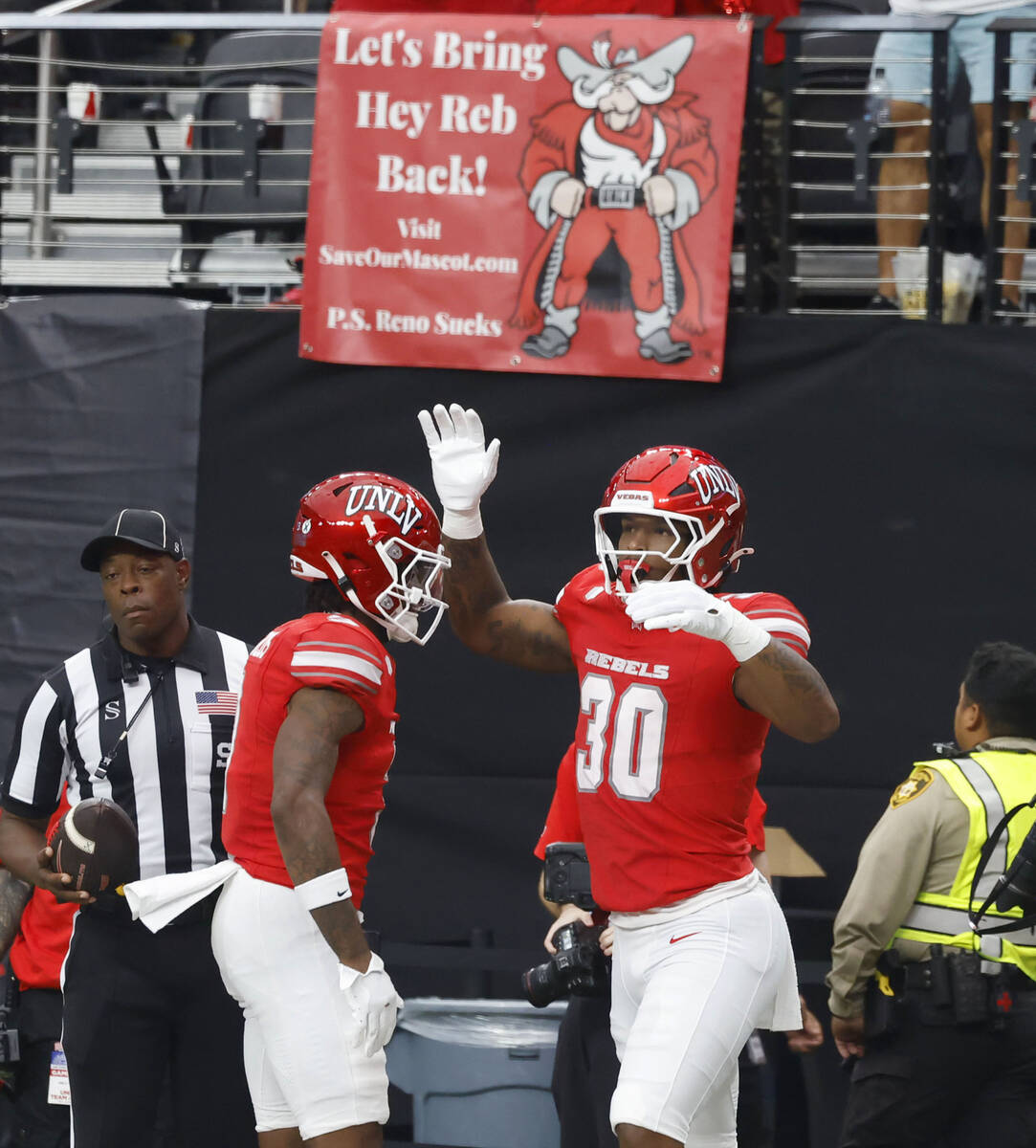 UNLV tight end Var'Keyes Gumms (30) celebrates his touchdown with wide receiver Daejon Rey ...