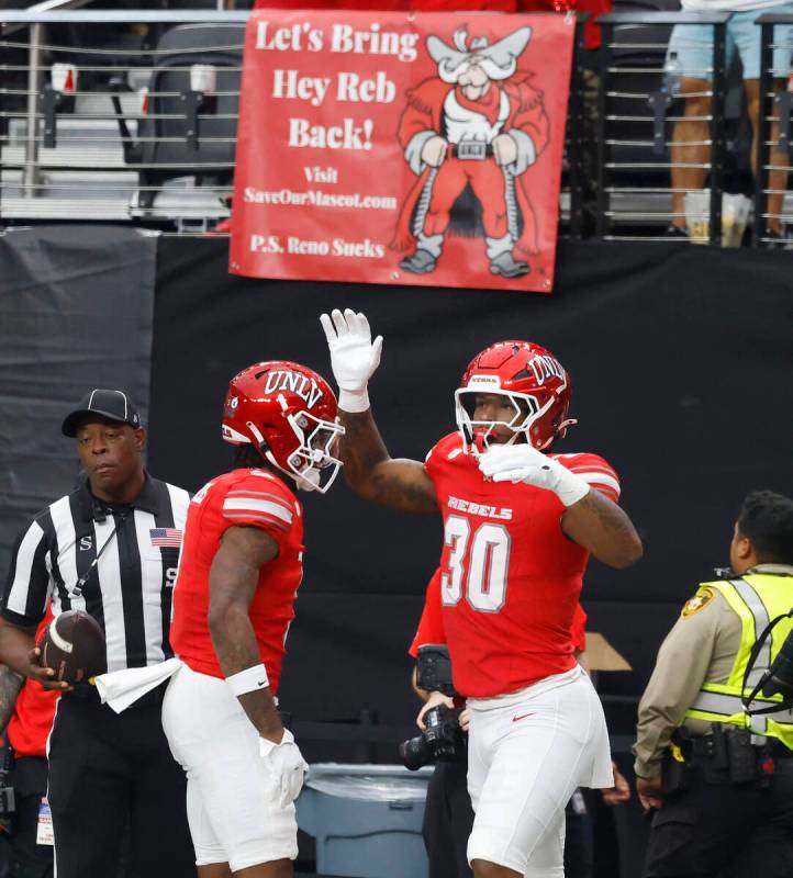 UNLV tight end Var'Keyes Gumms (30) celebrates his touchdown with wide receiver Daejon Rey ...