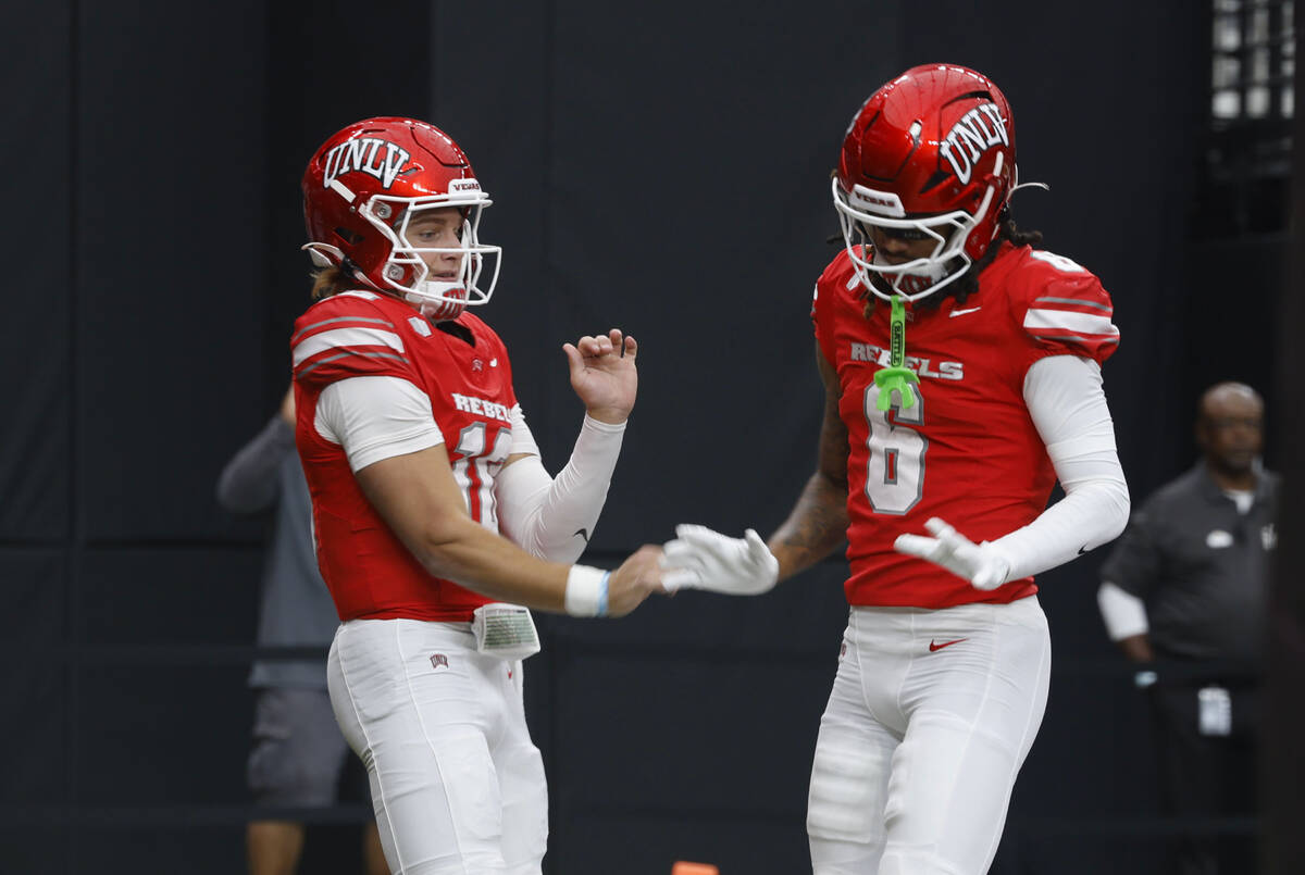 UNLV quarterback Anthony Colandrea (10) celebrates his touchdown with UNLV wide receiver Jaden ...