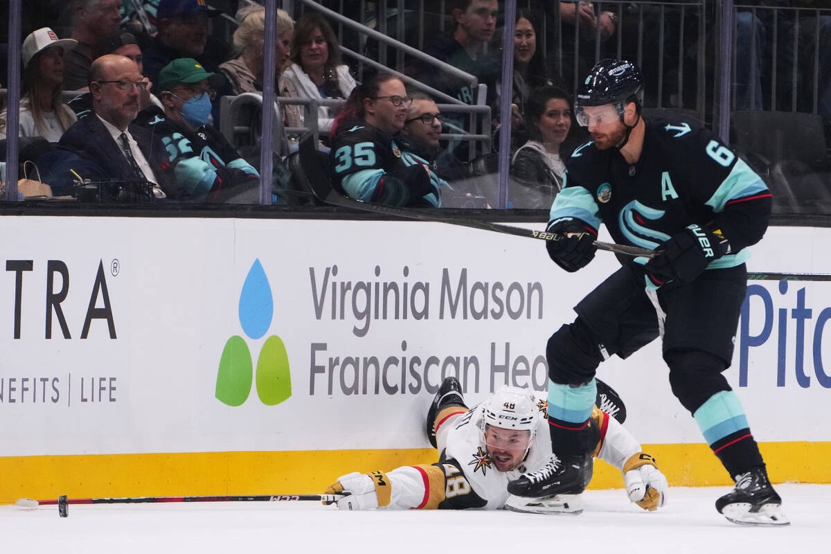 Vegas Golden Knights center Tomas Hertl (48) reaches for the puck against Seattle Kraken defens ...