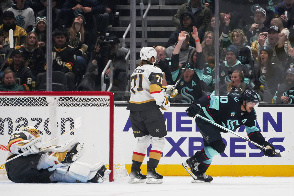 Seattle Kraken center Matty Beniers, right, reacts after scoring against Vegas Golden Knights g ...