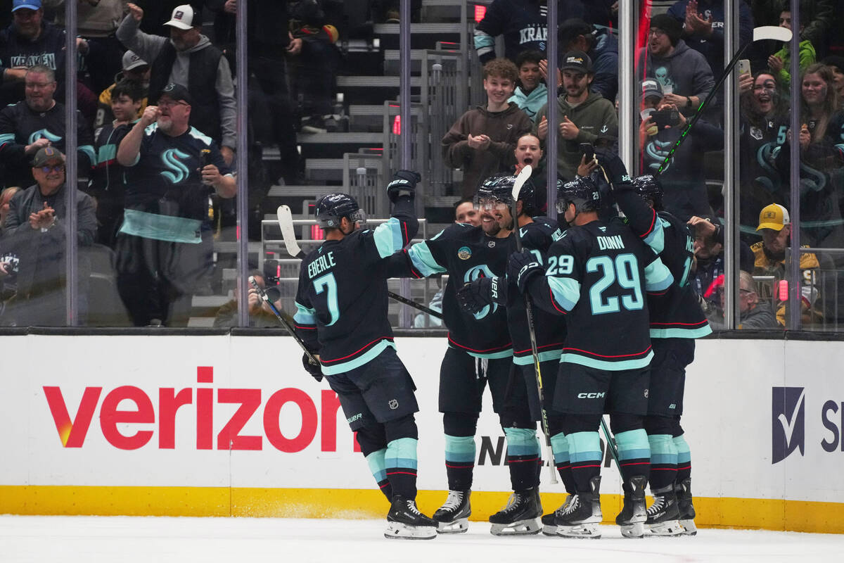 Seattle Kraken center Matty Beniers, third from left, celebrates his goal against the Vegas Gol ...
