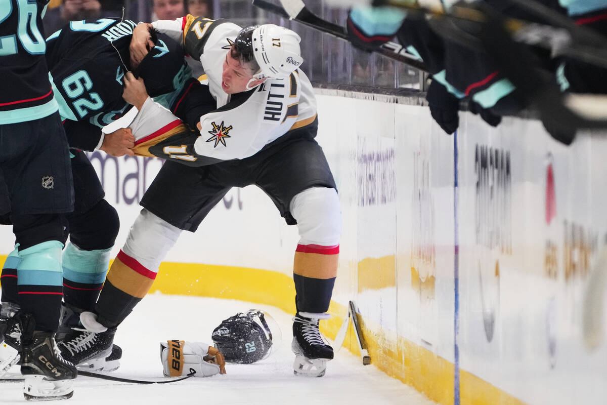 Seattle Kraken defenseman Brandon Montour (62) fights with Vegas Golden Knights defenseman Ben ...