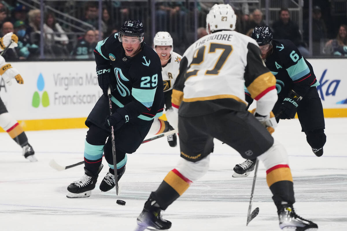 Seattle Kraken defenseman Vince Dunn (29) looks to move the puck past Vegas Golden Knights defe ...