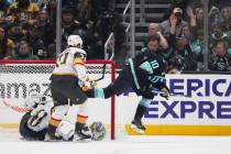 Seattle Kraken center Matty Beniers, right, reacts after scoring against Vegas Golden Knights g ...