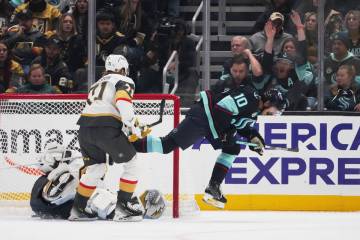 Seattle Kraken center Matty Beniers, right, reacts after scoring against Vegas Golden Knights g ...