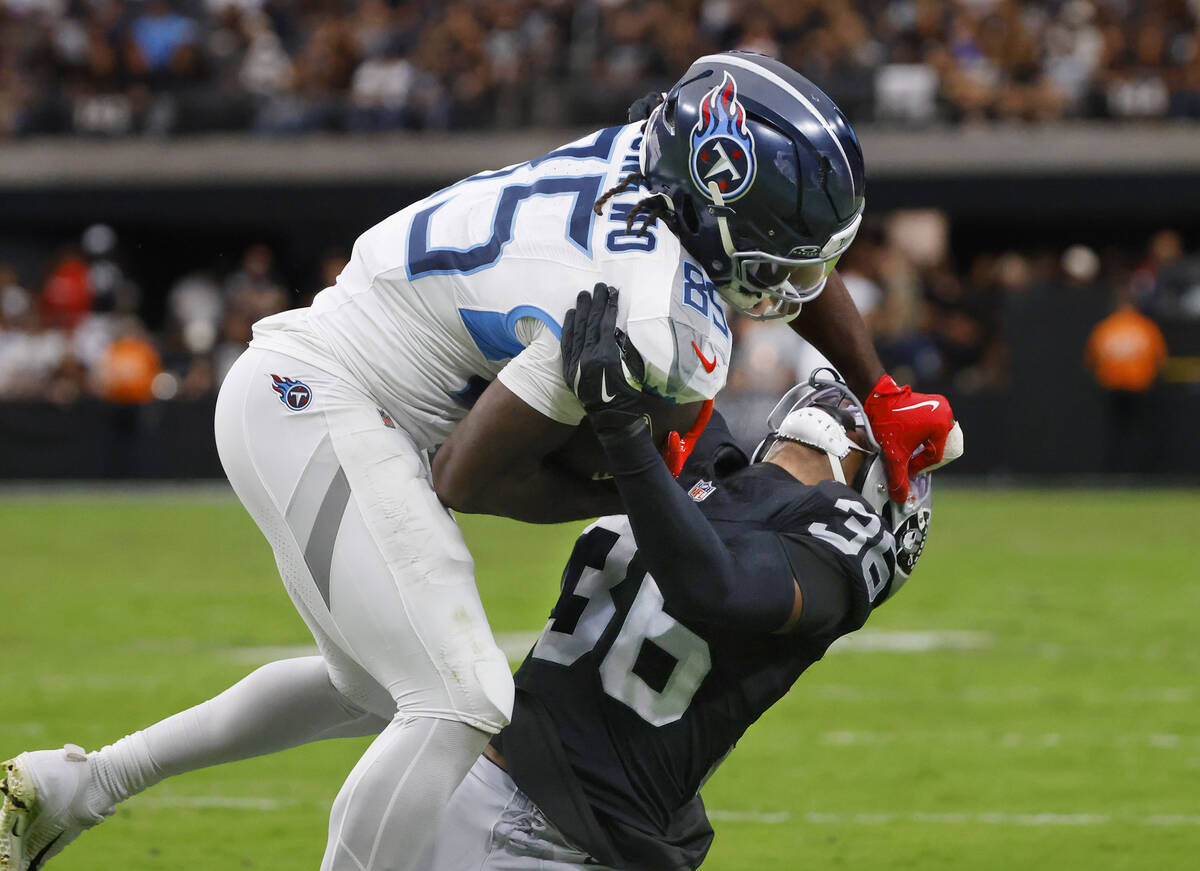 Tennessee Titans offensive tackle JC Latham (55) is taken down by Raiders cornerback Kyu Blu Ke ...
