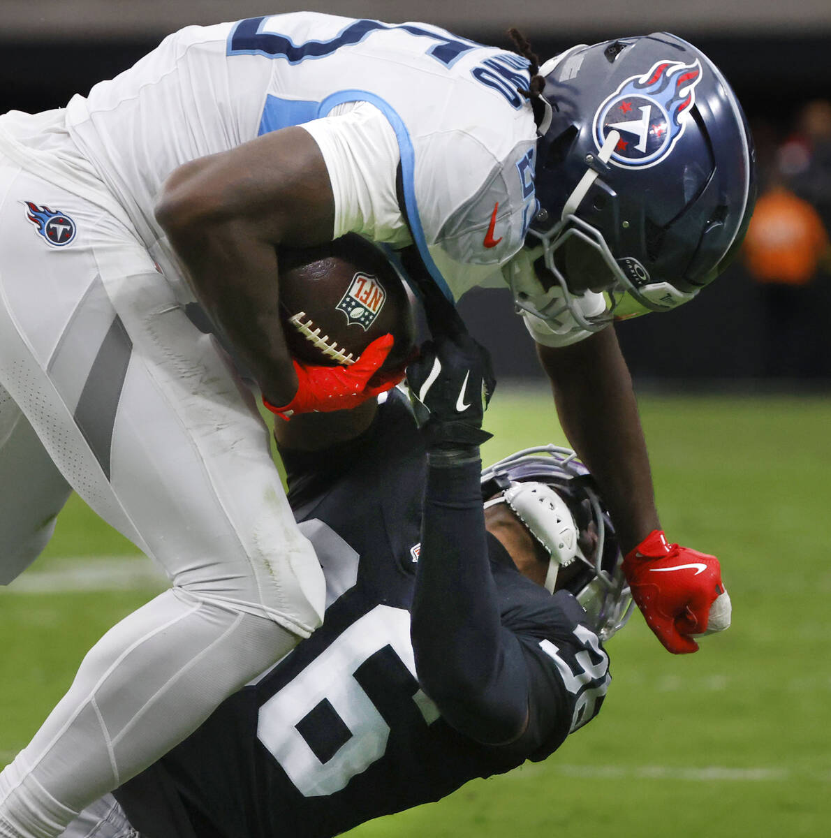 Tennessee Titans offensive tackle JC Latham (55) is taken down by Raiders cornerback Kyu Blu Ke ...