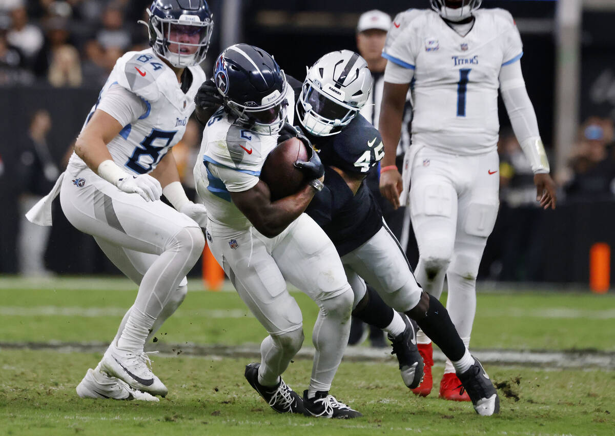 Raiders linebacker Devin White (45) takes down Tennessee Titans running back Tyjae Spears (2) d ...