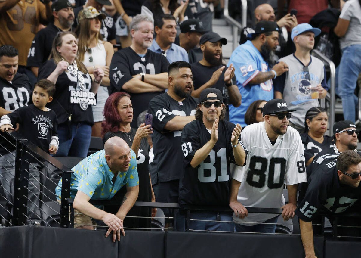 Raiders fans cheer for their team as they watch an NFL game against Tennessee Titans at Allegia ...
