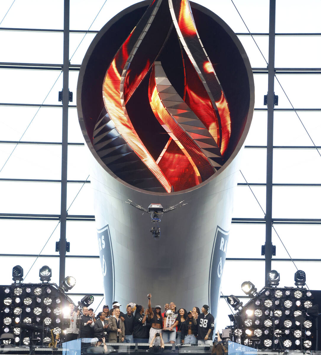 The Las Vegas Aces players lit the Al Davis Memorial Torch before an NFL game between Raiders a ...