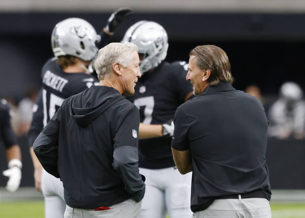 Raiders head coach Pete Carroll, left, and quarterbacks coach Greg Olson watch as quarterbacks ...