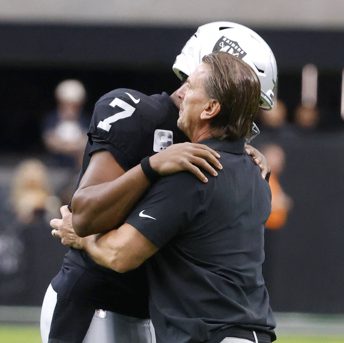 Raiders quarterbacks coach Greg Olson and quarterback Geno Smith greet each other before an NFL ...