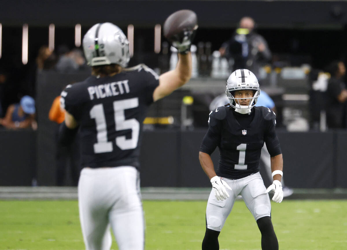 Raiders quarterback Kenny Pickett (15) throws a pass to wide receiver Tre Tucker (1) during a w ...