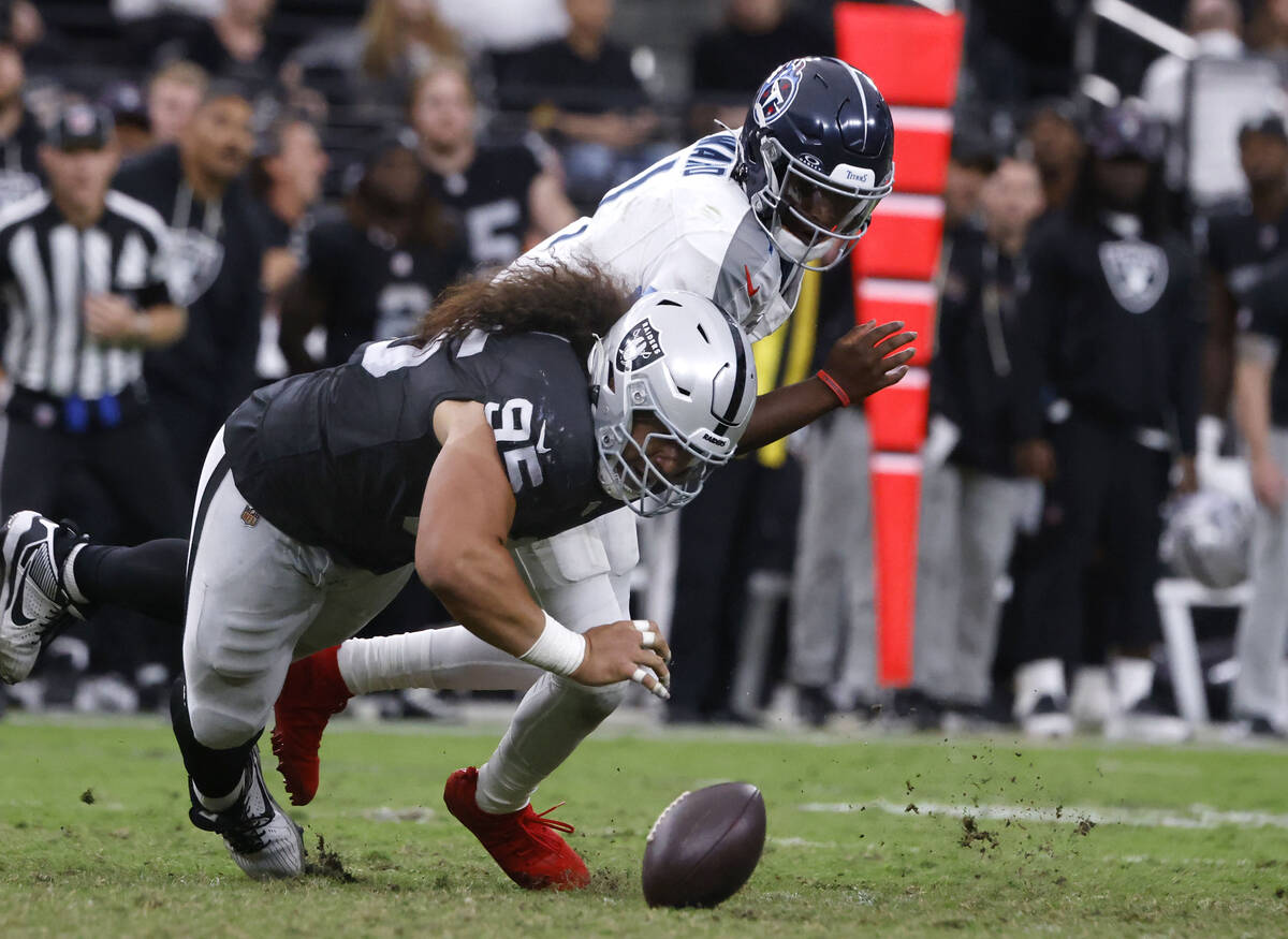 Raiders defensive tackle Leki Fotu (95) causes Tennessee Titans quarterback Cam Ward (1) to fum ...