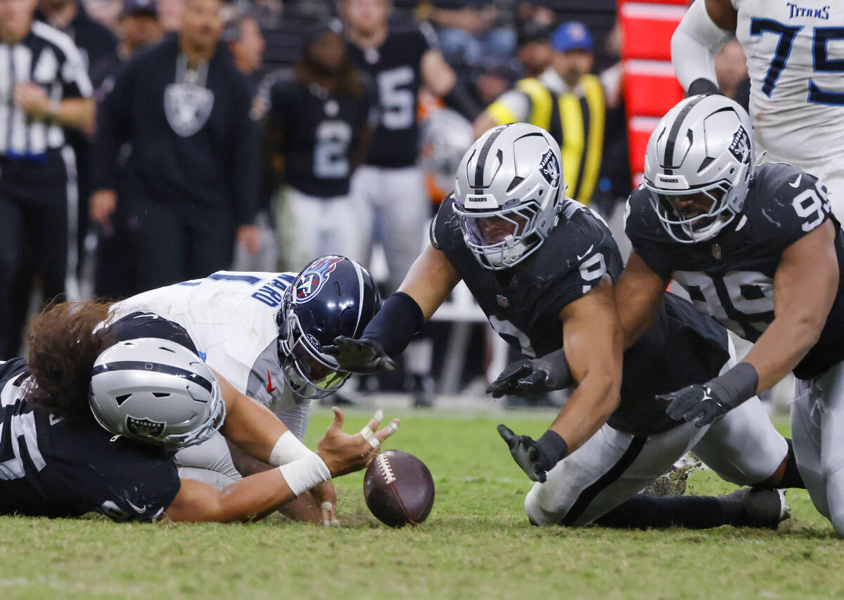 Raiders defensive tackle Thomas Booker (99) dives and recovers the ball after defensive tackle ...