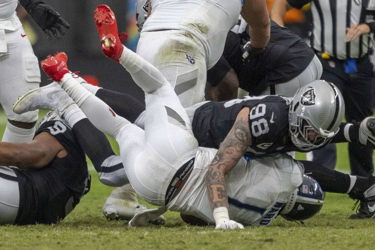 Raiders defensive end Maxx Crosby (98) sackes Tennessee Titans quarterback Cam Ward (1) during ...