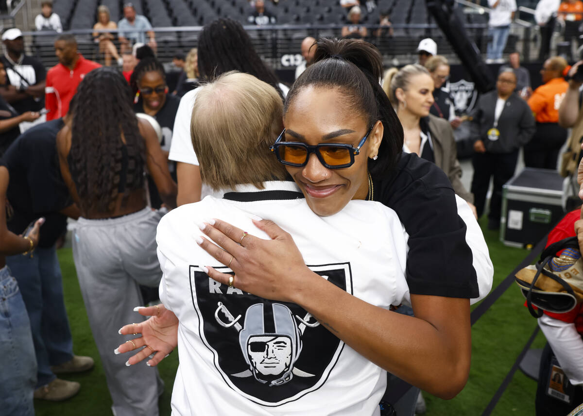 Aces' A'ja Wilson hugs Raiders and Aces owner Mark Davis before the start of an NFL g ...