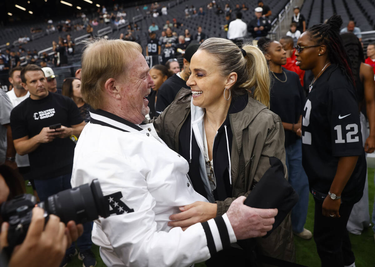 Aces coach Becky Hammon greets Raiders and Aces owner Mark Davis before the start of an NFL gam ...