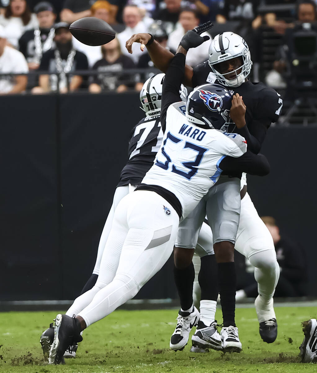 Raiders quarterback Geno Smith (7) throws under pressure from Tennessee Titans linebacker Jihad ...